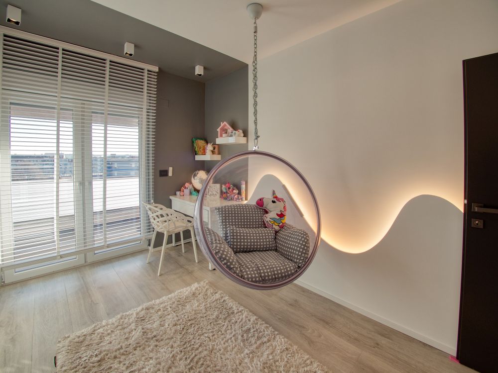 In the child's room there's a little desk area in one of the corners and a lounge chair hanging from the ceiling