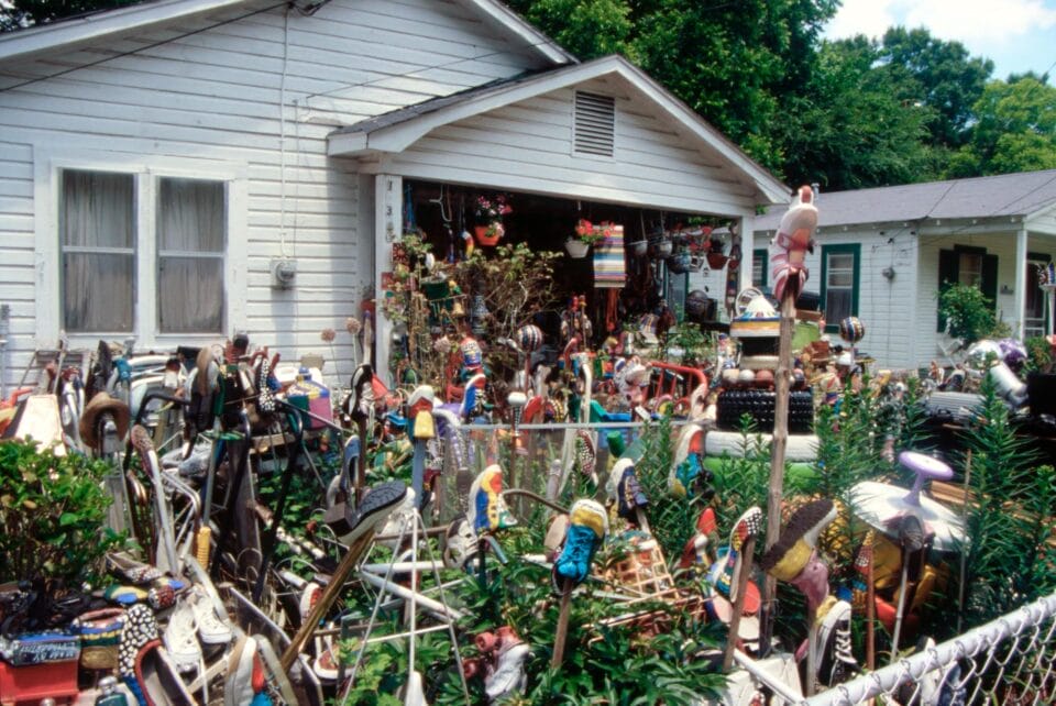 a photo of a yard covered in colorful found object assemblages