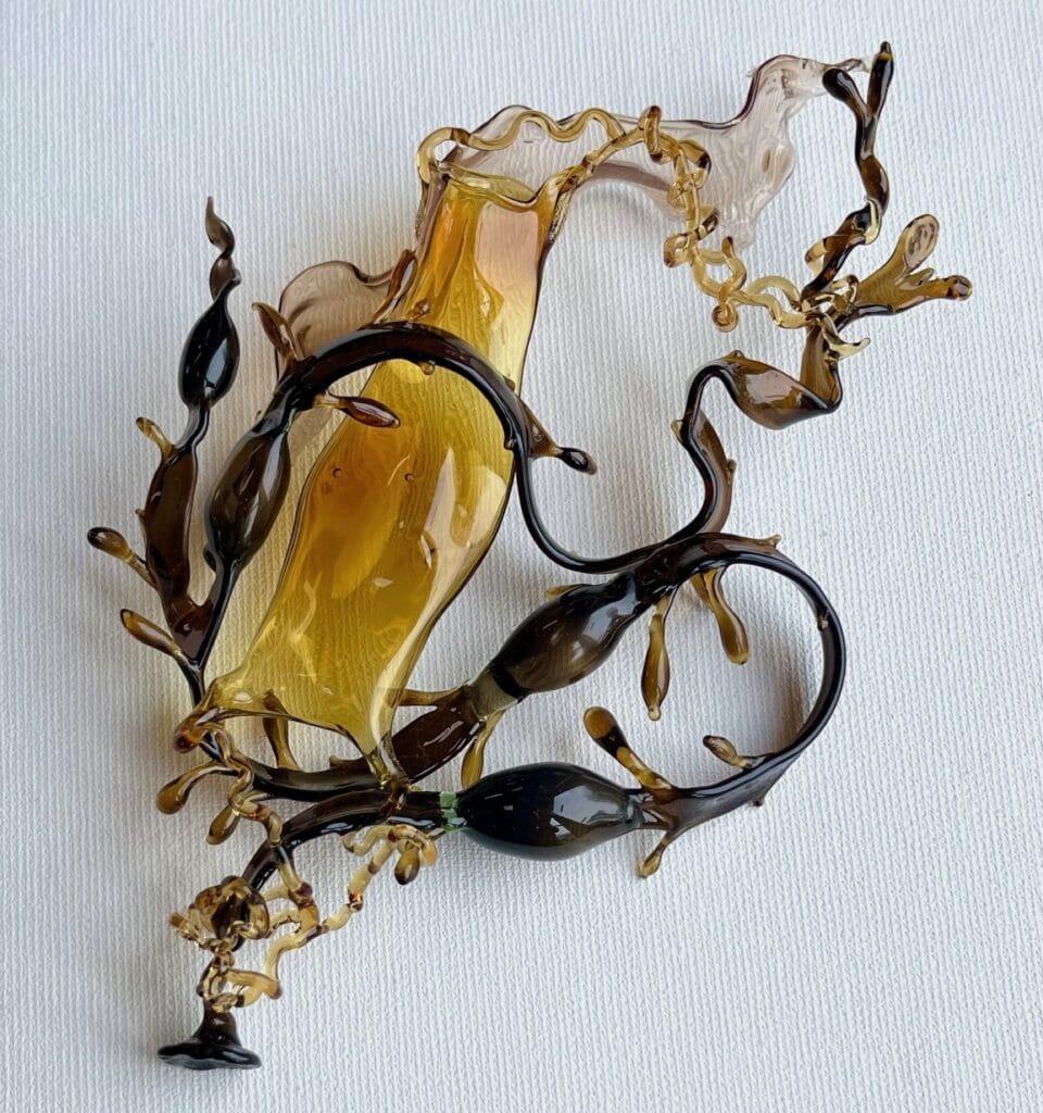 a glass sculpture depicting layers of kelp