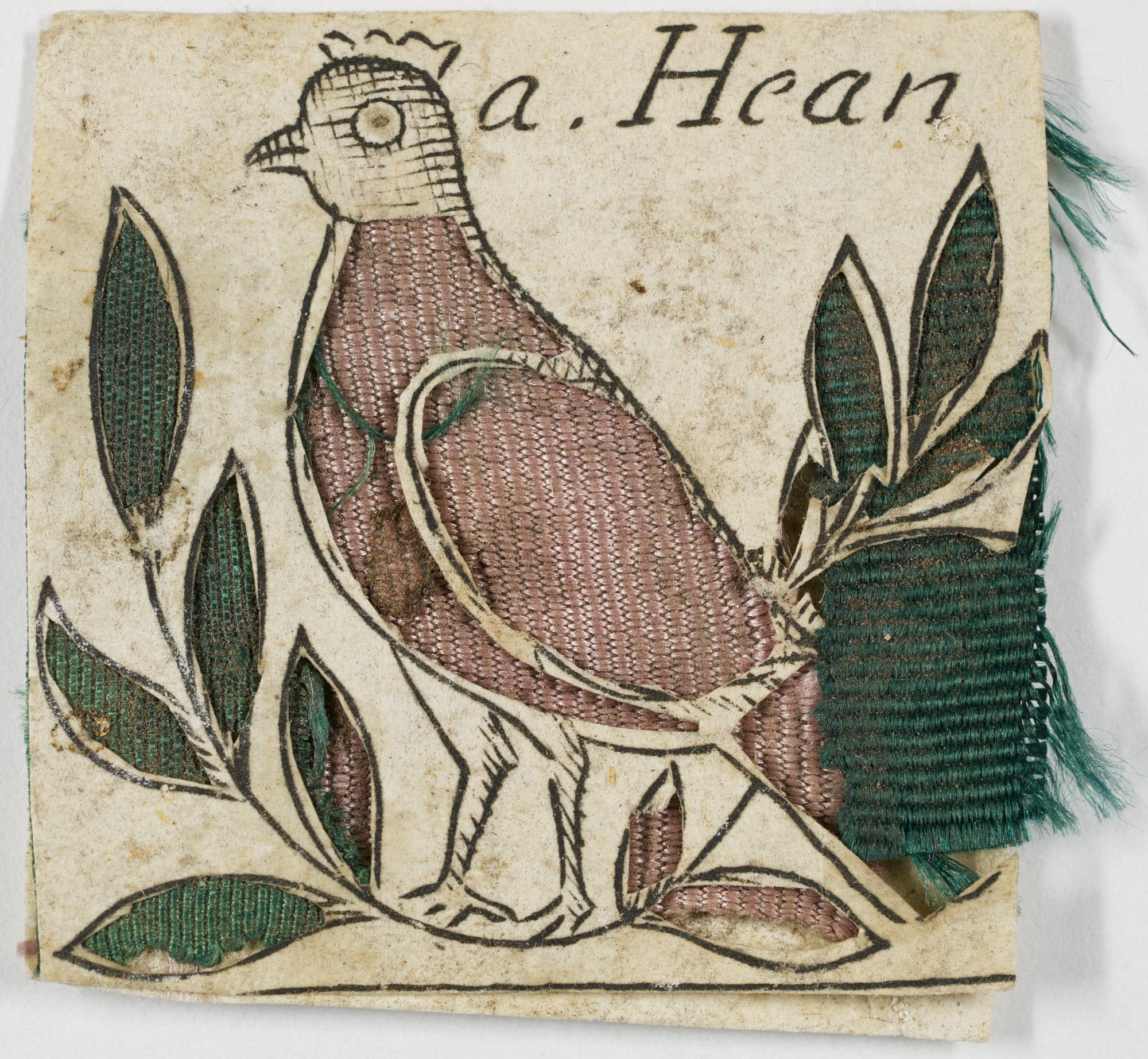 a papercut of a hen embroidered with pink and green